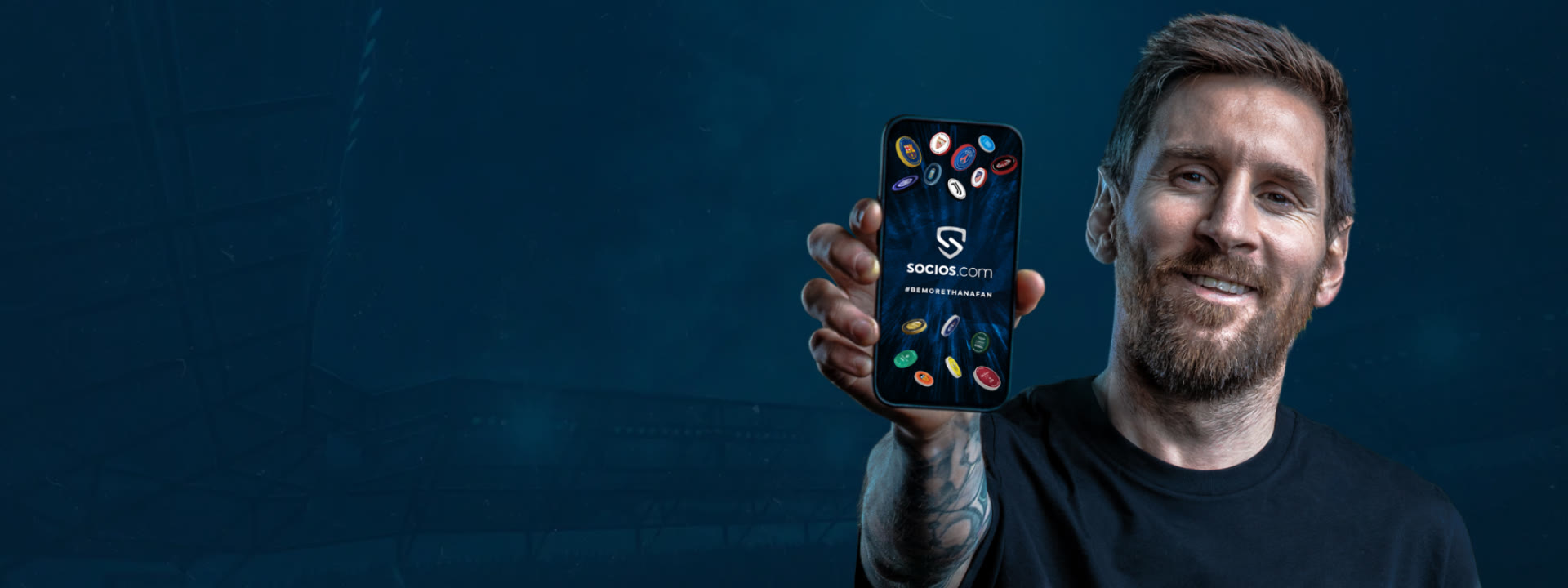 Messi holding up the Socios.com app against a dusk stadium