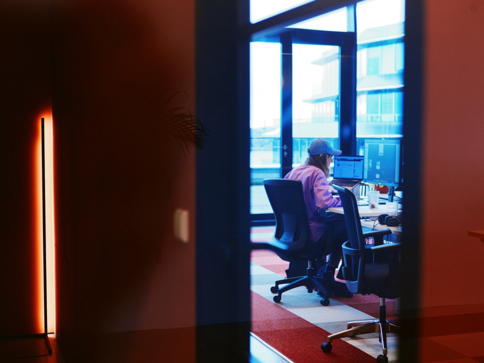 A team member at work in the Wave office, warm light in the foreground